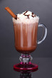 Photo: Layered coffee in glass on table on grey background Layered coffee in glass on table on grey background