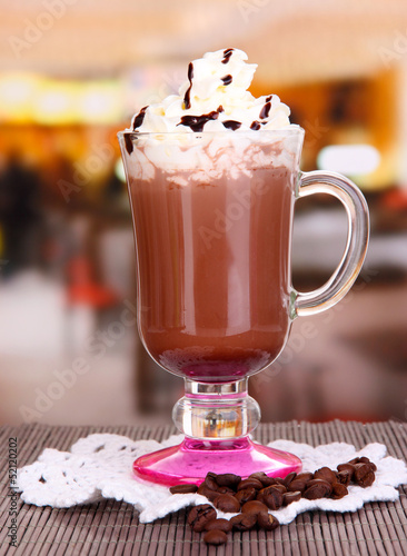 Photo: Layered coffee in glass on table on bright background Layered coffee in glass on table on bright background