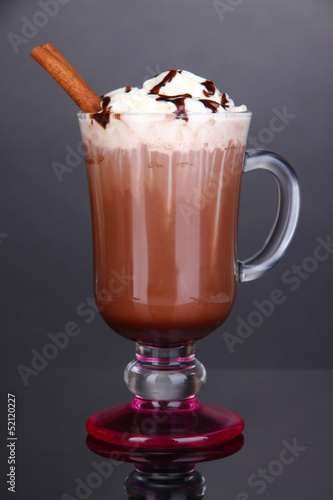Photo: Layered coffee in glass on table on grey background Layered coffee in glass on table on grey background