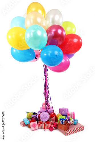 Photo: Many bright balloons and many gifts isolated on white Many bright balloons and many gifts isolated on white