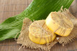 Hand-made soap and leaf on grey bamboo mat