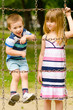 Brother and sister playing on the playground