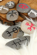Fortune telling  with symbols on stones on white fur background
