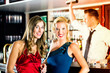 Photo: Young women and bartender in club or Bar Young women and bartender in club or Bar