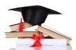 Grad hat with diploma and books isolated on white