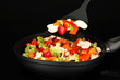 Vegetable ragout in pan, isolated on black