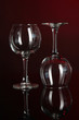 Two glasses on dark red background