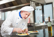 Chef garnishing a dish