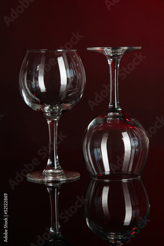 Photo: Two glasses on dark red background Two glasses on dark red background