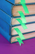 Many books with bookmarks on purple background close-up
