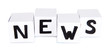 White paper cubes labeled "News" isolated on white