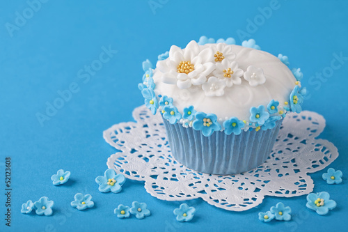 Photo: Cupcake with white and blue flowers Cupcake with white and blue flowers
