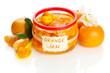 Orange jam with zest and tangerines, isolated on white