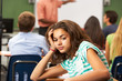 Bored Female Teenage Pupil In Classroom