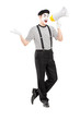 Full length portrait of a male mime artist speaking at loudspeak