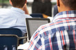 Male Pupil Using Digital Tablet In Classroom