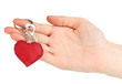 Key with leather trinket in hand isolated on white