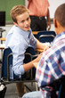 Two Male Pupils Talking In Class
