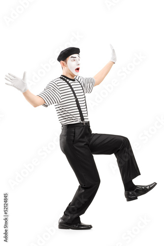 Photo: Full length portrait of a surpised mime artist gesturing with ha Full length portrait of a surpised mime artist gesturing with ha