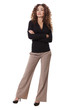 Confident woman stands with her arms crossed.