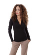 Confident woman stands with her hands in her pockets.