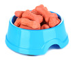 Dry dog treats in bowl isolated on white
