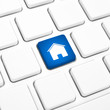 Home or real estate concept, house key on a keyboard