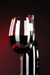 Wine in glass and wine bottle close-up on dark background