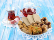 Sweet baklava on plate with tea on table