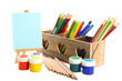 Different pencils in wooden crate, paints and easel, isolated