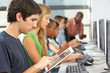 Boy Using Digital Tablet In Computer Class