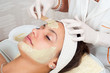 Beautiful young woman with natural facial mask