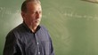 Education, teacher explaining lesson to students in college