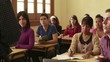 Professor speaking to group of students in school classroom