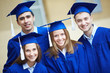 Friends in graduation gowns