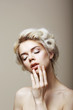 Purity. Sensual Blond Female with Closed Eyes touching her Face