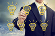 Photo: Businessman with light bulbs Businessman with light bulbs