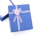 Photo: blue gift box with ribbon and flower on white with copy space blue gift box with ribbon and flower on white with copy space