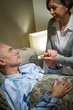 Photo: Old woman taking care of sick husband Old woman taking care of sick husband