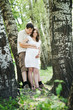 Pregnant wife and her husband hugging her