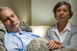 Caring wife holding sick senior husband's hands