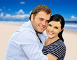 Beautiful young couple with sea in the background