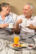 Mature couple enjoying breakfast at hotel room
