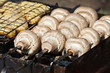 Cooking mushrooms (champignons  Agaricus bisporus) on grill