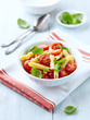 Penne with roasted cherry tomatoes and basil leaves
