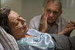 Sick mature woman lying in bed