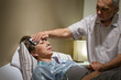Caring senior man helping his sick wife