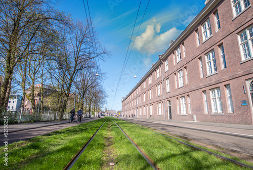 Photo: Amsterdam Buildings and tram railway in spring Amsterdam Buildings and tram railway in spring
