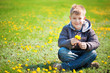 boy with dandelions in a green park. spring