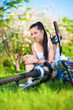 girl fell from the bike in a green park